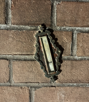 The “Meed” mezuzah, mounted on a brick wall, on display at the United States Holocaust Memorial Museum. Photograph by Oren Baruch Stier