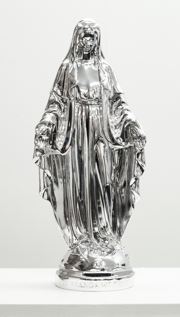 Statue of Mary, in chrome, in front of a white background.