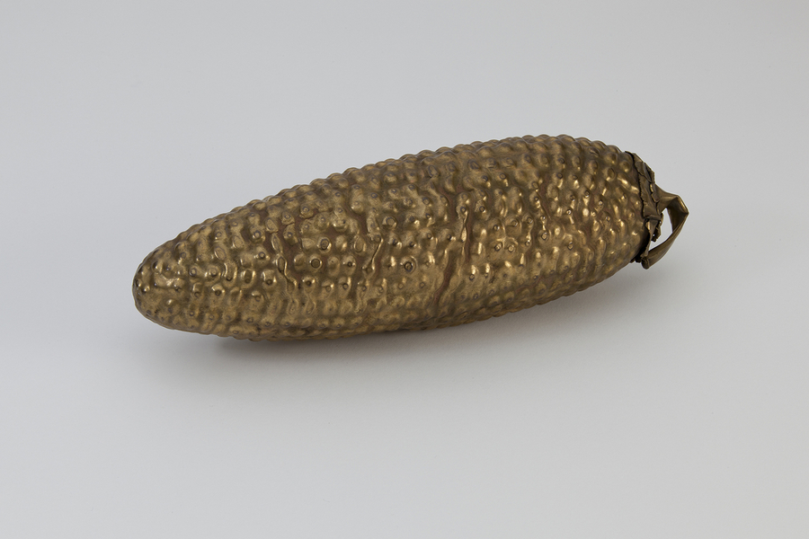 A golden statuette depicts an ear of corn lying shucked and with its kernels exposed.