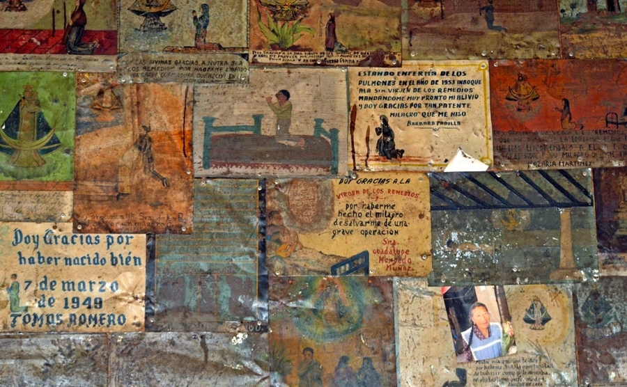 Devotional paintings pasted in a collage style onto a wall