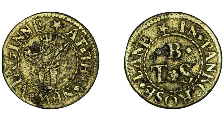 The front and reverse of a golden trade token are shown side by side. The front depicts a stylized indigenous man in a headpiece smoking a pipe and holding a tobacco leaf. The back is inscribed with the initials "B / T . S." and "IN . PANKCROSE . LANE."