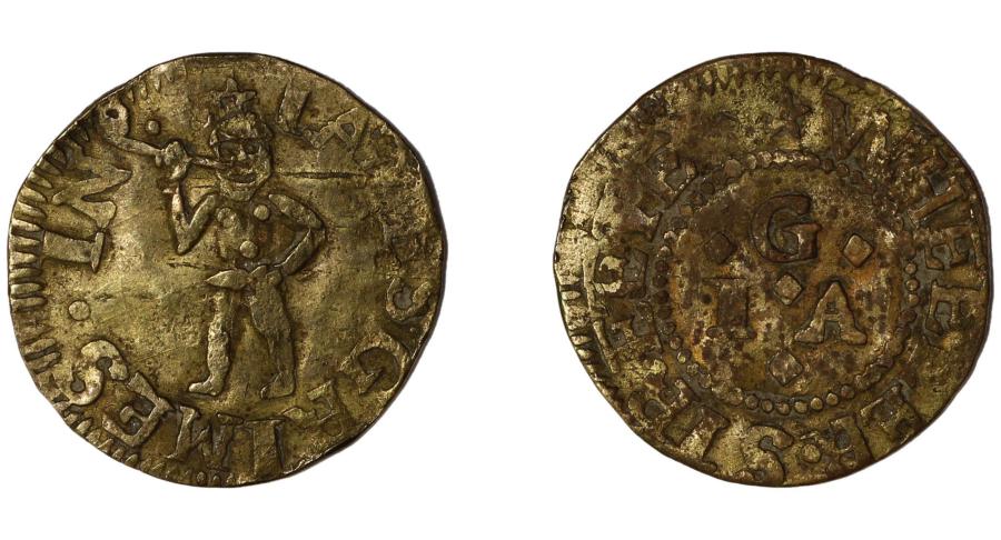 The front and reverse of a golden trade token are shown side by side. The front depicts a stylized indigenous man smoking a pipe. The back is inscribed with the initials "G / I . A." and "WHEELER STREET."