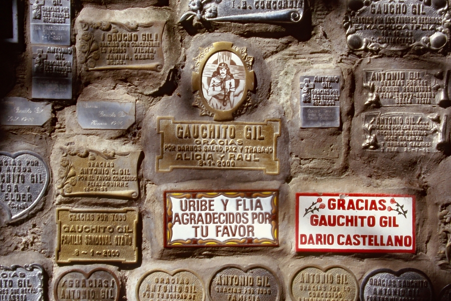 Votive plaques pasted onto a wall