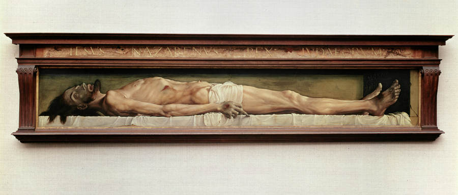 A long, horizontal painting depicts a blank-eyed cadaver laid on cloth-covered slab. The light-skinned body is skeletal and nearly naked save for a white cloth over the hips. His head, pierced rib, and wounded hands and feet are a bruised, green color.